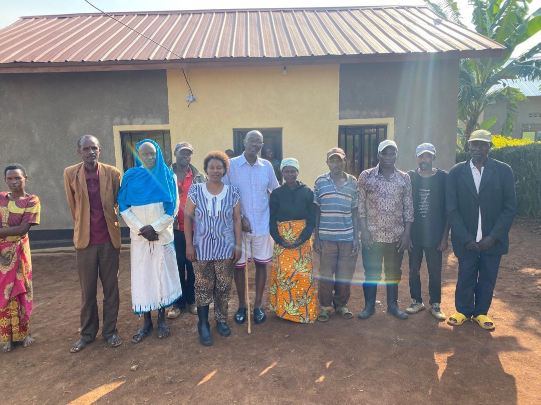 Community members and E&B representatives at a house handover event