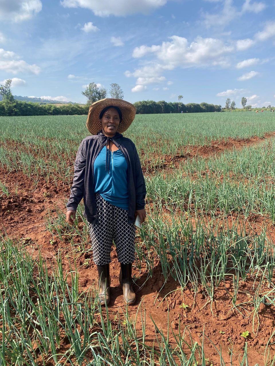 Mrs. Mugeni Beathe, Founder & CEO of E&B Seed Co Ltd, in the field